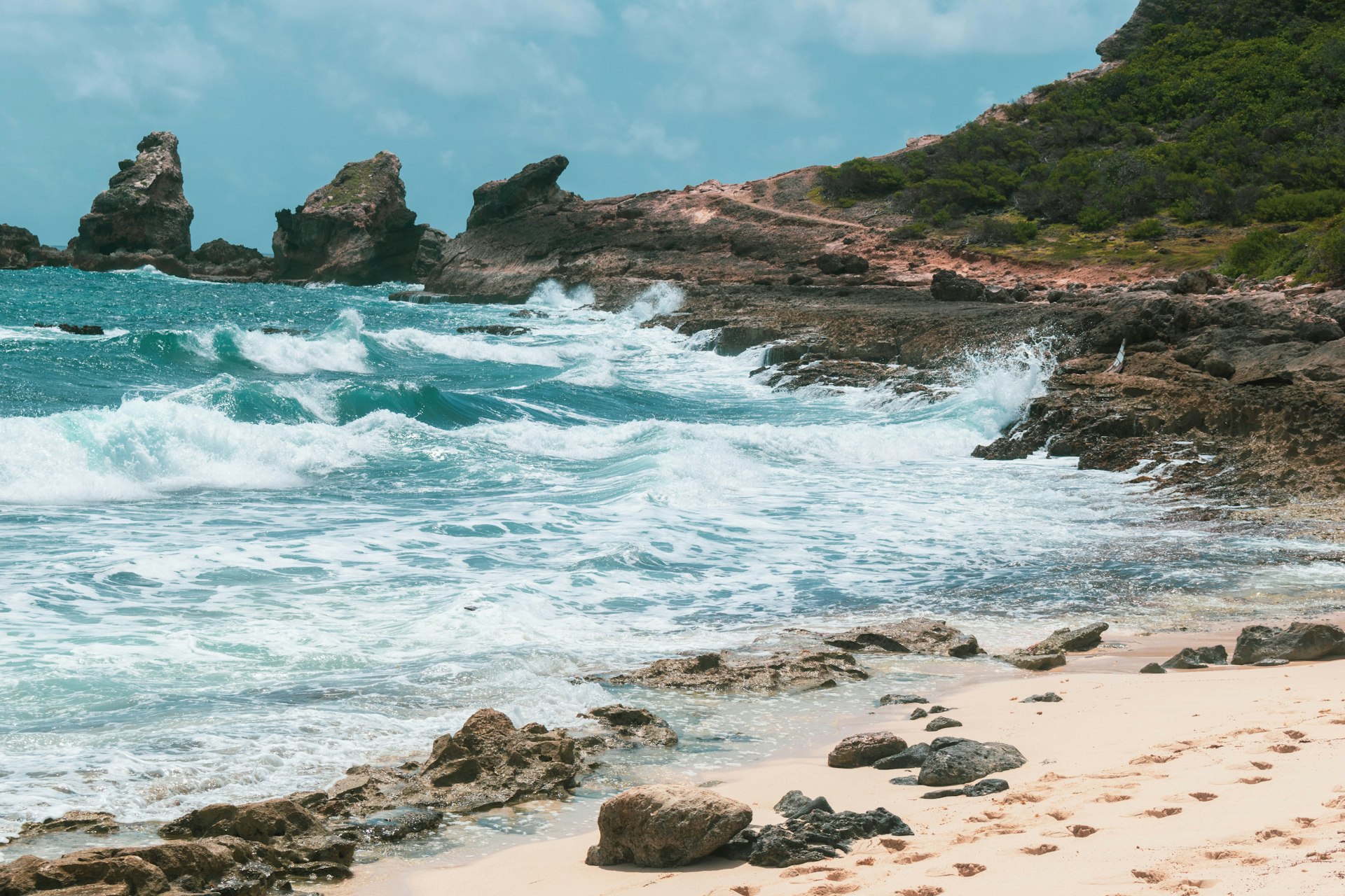 brown rocky shore with ocean waves during daytime